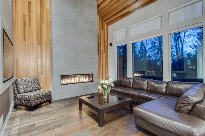 New build - The stone and fireplace surrounded by cedar inlay provided a strong statement feature for the open concept living area. 